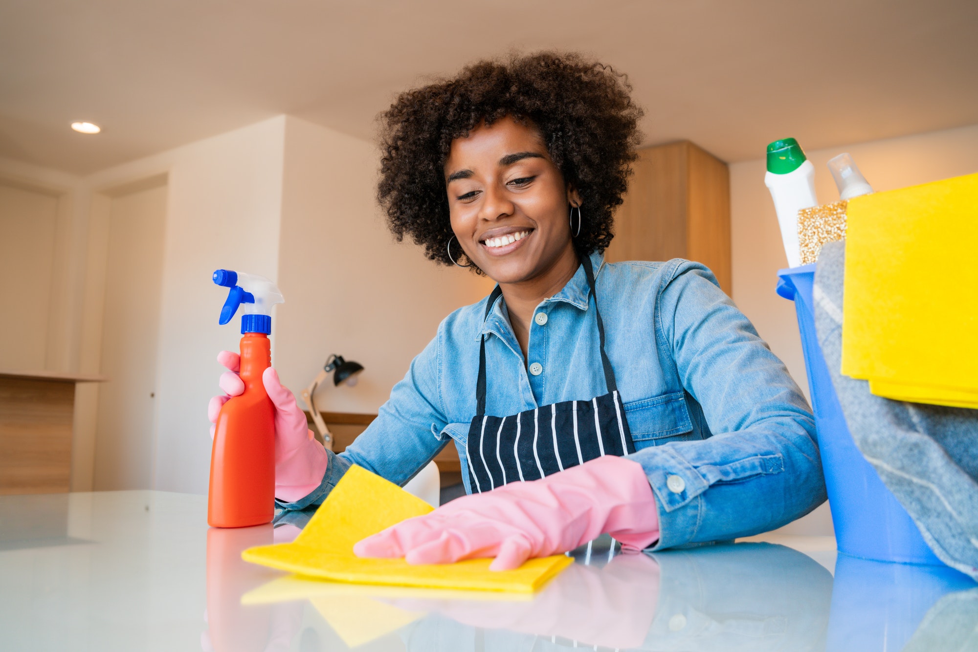 afro woman cleaning new home